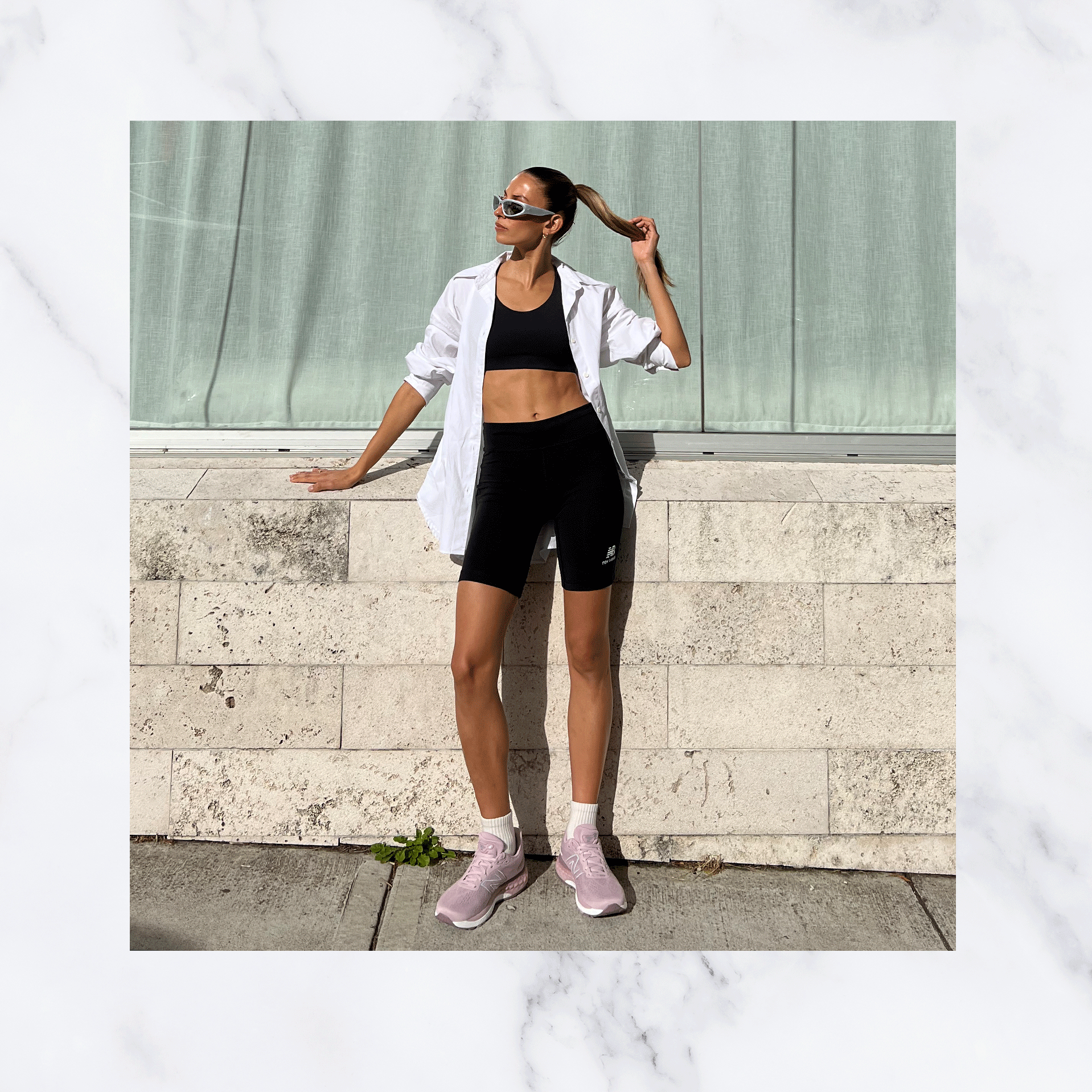 a woman standing holding her ponytail wearing New Balance 880 shoes and apparel